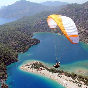 Ölüdeniz Yamaç Paraşütü Fiyat Ölüdeniz Yamaç Paraşütü Fiyatı Ölüdeniz, Muğla iline bağlı Fethiye ilçesine ait bir tatil beldesidir. Ölüdeniz, dünyaca ünlü bir plajı ve turkuaz renkli denizi ile bilinir. Ayrıca, Ölüdeniz'in çevresindeki Babadağ Dağ, yamaç paraşütü için popüler bir destinasyondur. Fethiye Ölüdeniz plajı manzarasını en iyi izlemenin en iyi yolu hiç şüphesiz Ölüdeniz yamaç paraşütü dür. Babadağ Dağı, Ölüdeniz'in hemen arkasında yükselen bir dağdır ve zirvesinden muazzam bir manzara sunar. Bu özellik, yamaç paraşütü tutkunları için eşsiz bir deneyim sunar. Babadağ'dan atlayan yamaç paraşütçüleri, Ölüdeniz'in eşsiz manzarası ve turkuaz renkli denizi eşliğinde serbestçe uçabilirler. Yamaç paraşütü, genellikle deneyimli eğitmenler eşliğinde gerçekleştirilir ve hayatınızın en unutulmaz anı Babadağ'ın zirvesinden başlar. Ölüdeniz'in ünlü Belcekız Plajı'na iniş yapmak, bu aktivitenin keyifli bir yönüdür. Eğer macera ve adrenalini seven birisiyseniz, Ölüdeniz'de yamaç paraşütü deneyimi yaşamanızı tavsiye ederiz. Ancak, bu tür aktiviteleri gerçekleştirmeden önce güvenilir yolu profesyonel pilotlar ile hizmete veren Butterfly Paragliding şirketini tercih etmenizdir. Ölüdeniz Yamaç Paraşütü yaz – kış hava şartlarına bağlı olarak yapılmaktadır. Paraşüt pistleri 1200-1700-1800-1970 metre de yer almaktadır. Ölüdeniz den hareket ile yaklaşık 30 dakika sonra uçuş yapılacak pistte ulaşır. Burada pilotların hazırlıkları sonrasında pilot ve yolcu pistten aşağıya doğru koşarak kalkış yapılmaktadır. Yamaç paraşütü yapmak için bayanlarda 80 kğ – erkeklerde ise 100 kğ üzerinde olmamanız gerekmektedir. Uçuş sonrası inişler Ölüdeniz plajına yapılmaktadır. Ölüdeniz Yamaç Paraşütü Fiyatı Ölüdeniz paraşüt fiyatı dönemsel olarak değişmektedir. Yamaç paraşütü fiyatlarına pist kullanım ücreti, siğorta, dağa çıkış ücreti dahildir. Gopro kamera foto video ve 360 derece panoramik fotoğraflar ise fiyata dahil değildir. Ölüdeniz Yamaç Paraşütü Fiyat